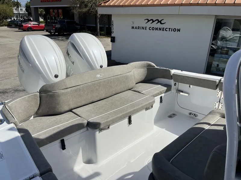 Slide: The Image of 2025 Sea Hunt Ultra 265 SE boat interior with cushioned seating and dual Yamaha engines. - 27