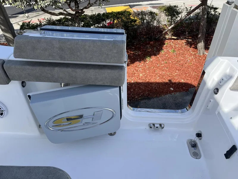 Slide: The Image of 2025 Sea Hunt Ultra 265 SE boat interior with seating and open access door. - 32