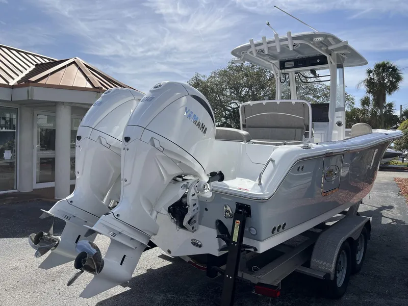 Slide: The Image of 2025 Sea Hunt Ultra 265 SE boat with dual Yamaha engines on a trailer. - 6