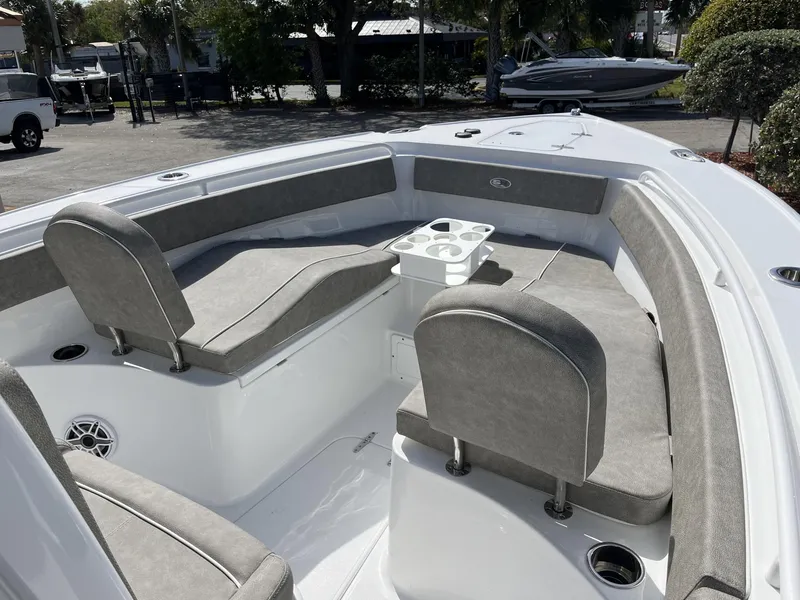 Slide: The Image of 2025 Sea Hunt Ultra 265 SE boat interior with gray seating and cup holders. - 20
