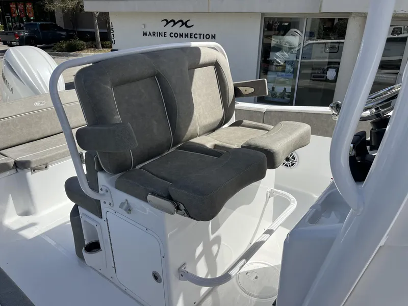 Slide: The Image of 2025 Sea Hunt Ultra 265 SE boat seat, gray upholstery, Marine Connection dealership background. - 25
