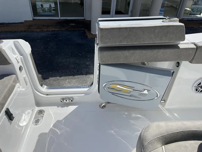 Slide: The Image of 2025 Sea Hunt Ultra 265 SE boat interior with open side door and seating. - 28
