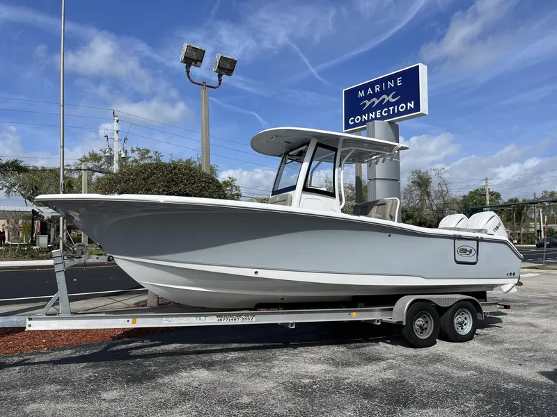 Slide: The Image of 2025 Sea Hunt Ultra 265 SE boat on trailer at Marine Connection dealership. - 1