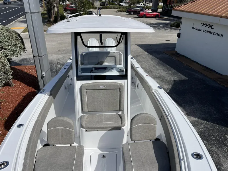 Slide: The Image of 2025 Sea Hunt Ultra 265 SE boat with cushioned seating, parked at Marine Connection. - 22