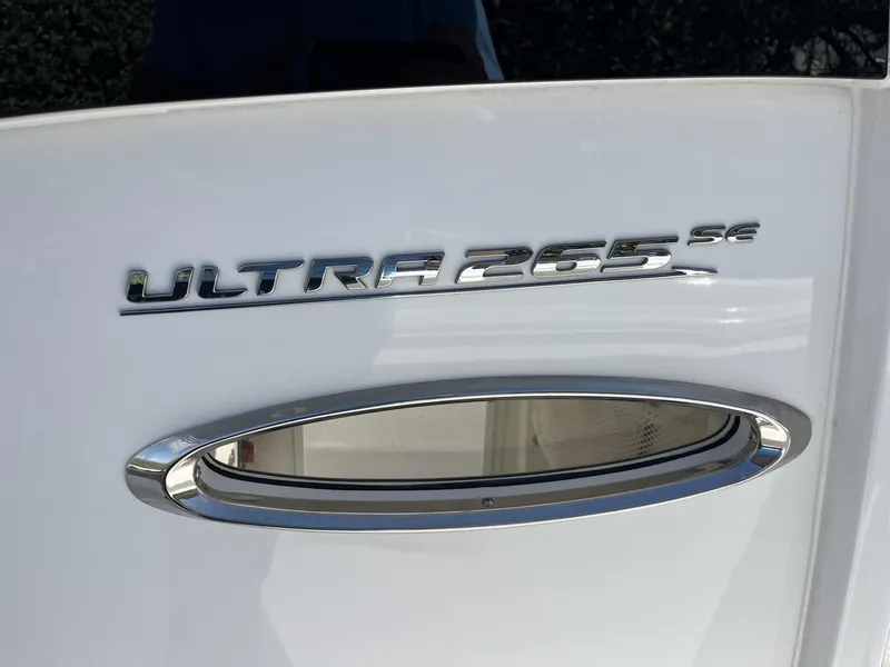 Slide: The Image of 2025 Sea Hunt Ultra 265 SE boat emblem on white surface. - 26