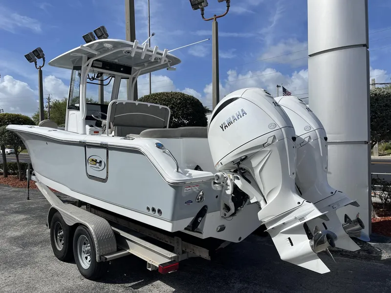 Slide: The Image of 2025 Sea Hunt Ultra 265 SE boat with dual Yamaha engines on a trailer. - 4