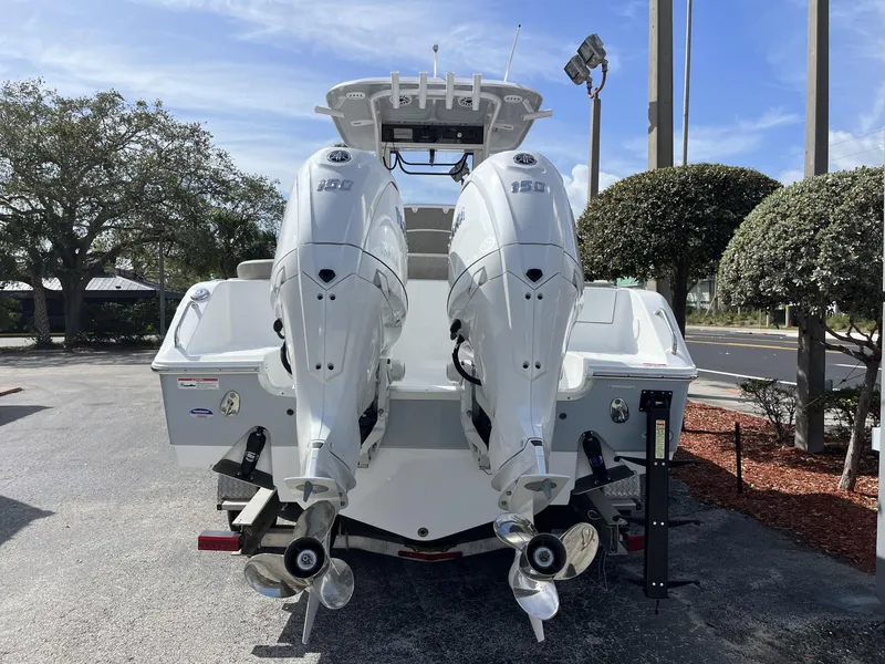 Slide: The Image of 2025 Sea Hunt Ultra 265 SE boat with dual outboard engines, rear view. - 5
