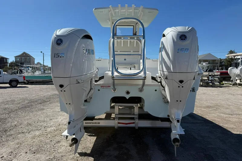 Slide: The Image of 2026 World Cat 235 TE boat with dual Yamaha 150 outboard engines, parked outdoors. - 26