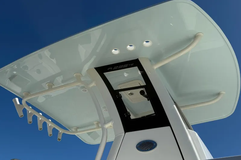 Slide: The Image of 2026 World Cat 235 TE boat T-top against clear blue sky. - 30