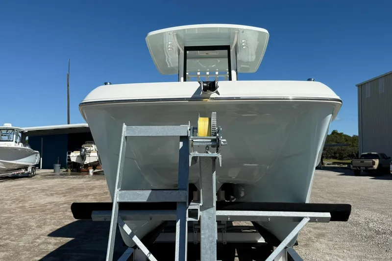 Slide: The Image of 2026 World Cat 235 TE boat on trailer under clear blue sky. - 31