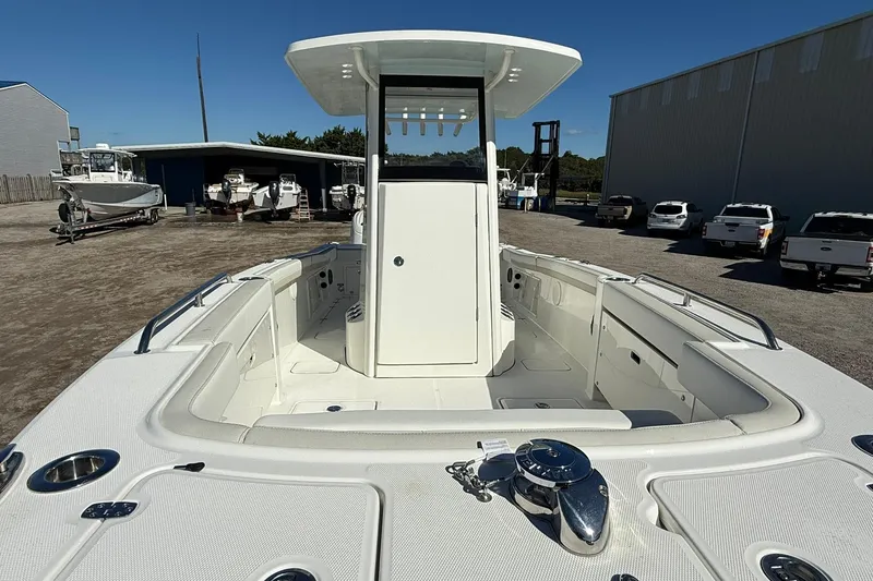 Slide: The Image of 2026 World Cat 235 TE boat with spacious deck and modern design in a marina setting. - 32