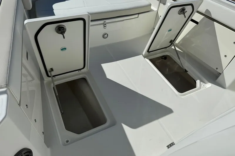 Slide: The Image of 2026 World Cat 235 TE boat storage compartments open, showcasing interior space. - 37