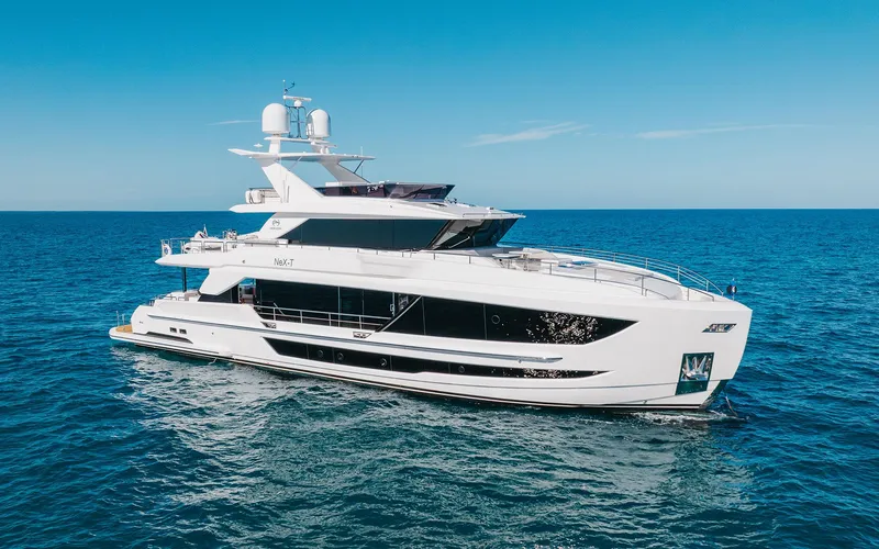 The Image of Luxurious 2022 Horizon FD 92 yacht cruising on open sea under clear blue sky. - 1