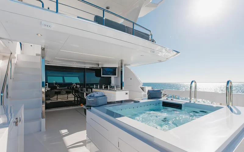 Slide: The Image of Luxurious Horizon FD 92 yacht deck with jacuzzi, ocean view, and modern amenities, 2022 model. - 22