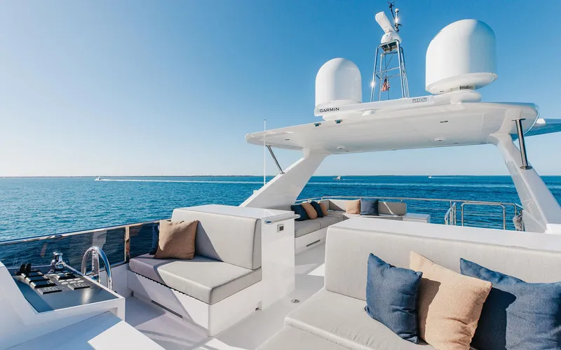 Slide: The Image of Luxurious Horizon FD 92 yacht deck with plush seating, set against a serene ocean backdrop. - 24