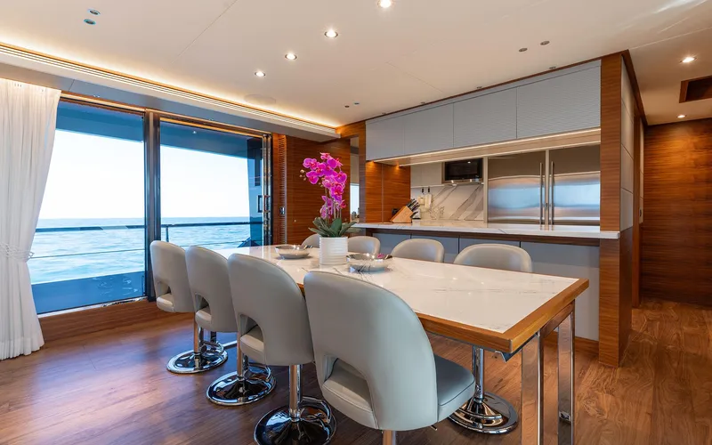 Slide: The Image of Luxurious yacht interior with dining area, modern kitchen, and ocean view. Horizon FD 92, 2022. - 5