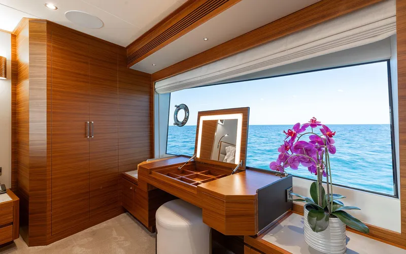 Slide: The Image of Luxurious Horizon FD 92 yacht interior with vanity, ocean view, and vibrant orchid. - 9