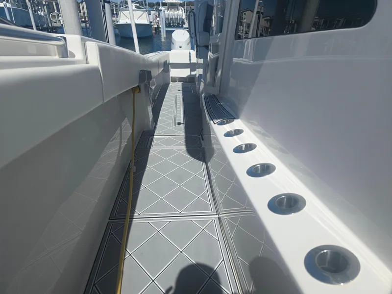 Slide: The Image of 2024 Invincible 43 Open Fisherman boat deck with rod holders and sleek design. - 10