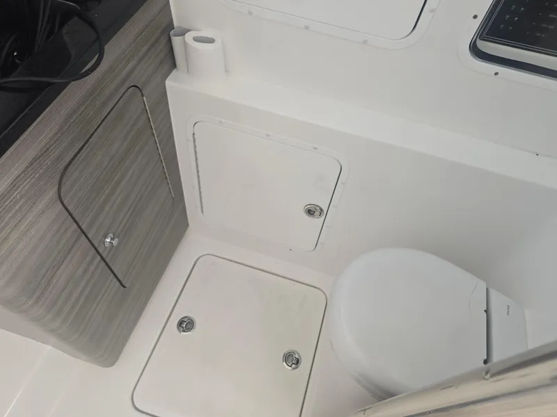 Slide: The Image of 2024 Invincible 43 Open Fisherman boat interior with toilet and storage compartments. - 18