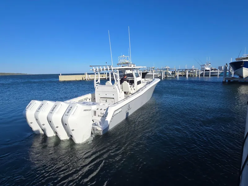 Slide: The Image of 2024 Invincible 43 Open Fisherman boat with multiple engines docked in marina. - 31