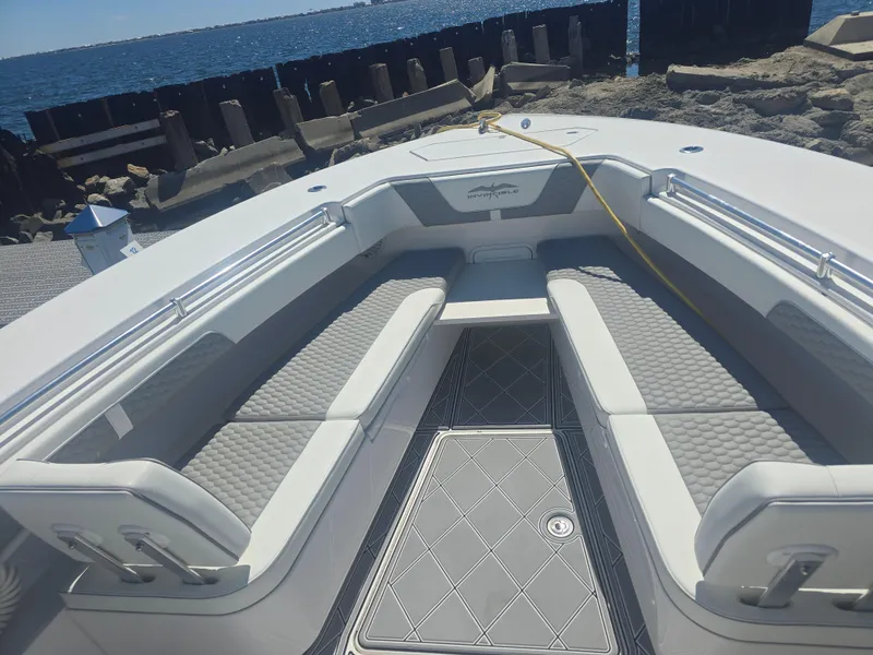 Slide: The Image of 2024 Invincible 43 Open Fisherman boat interior with cushioned seating and ocean view. - 4
