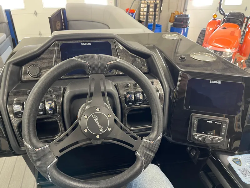 Slide: The Image of 2025 Bentley Pontoons Elite 253 Swingback Tower dashboard with steering wheel and controls. - 12