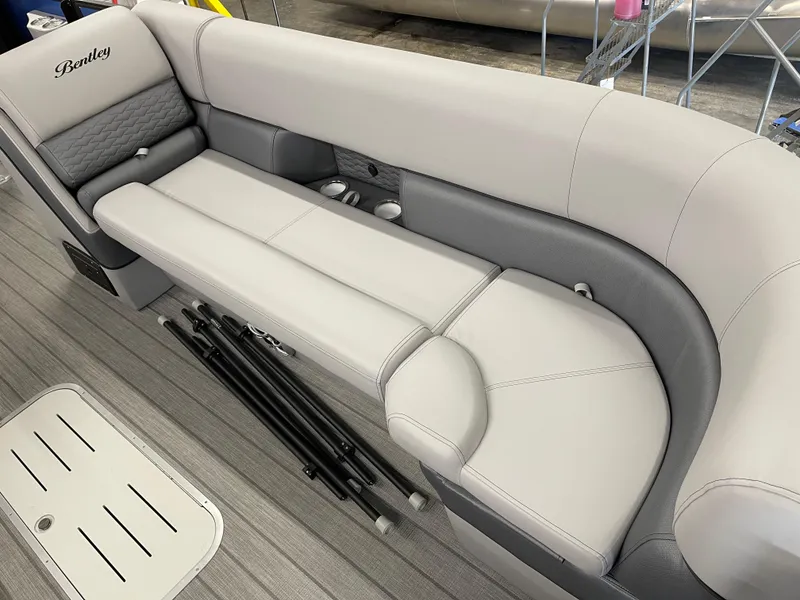 Slide: The Image of 2025 Bentley Pontoons Elite 253 Swingback Tower interior seating, featuring luxurious gray upholstery. - 9