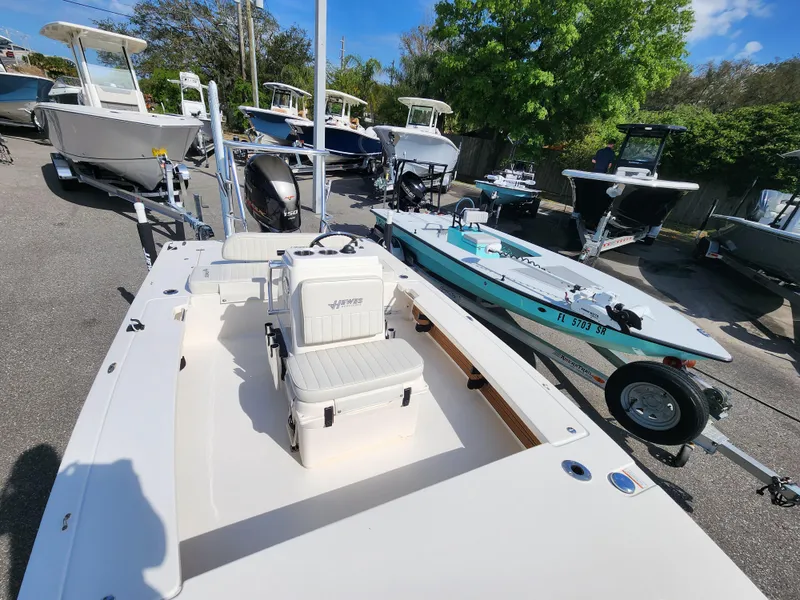 Slide: The Image of 2020 Hewes Redfisher 18 boat in a marina, surrounded by other boats. - 13