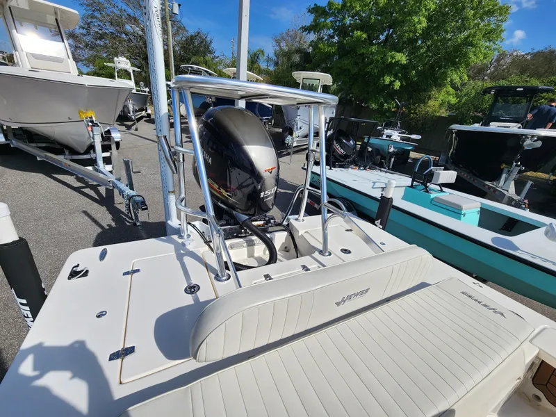 Slide: The Image of 2020 Hewes Redfisher 18 boat with outboard motor, parked on a trailer. - 3