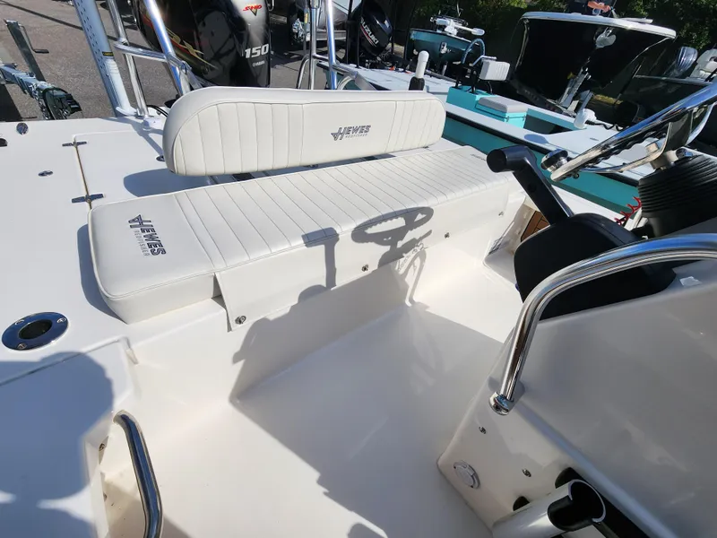 Slide: The Image of 2020 Hewes Redfisher 18 boat interior with steering wheel and seating area. - 5
