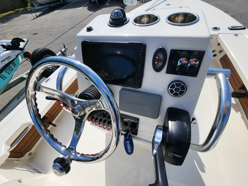 Slide: The Image of 2020 Hewes Redfisher 18 boat console with steering wheel and navigation controls. - 7