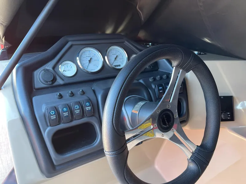 Slide: The Image of 2025 Bentley Pontoons Legacy 200 Swingback dashboard with steering wheel and gauges. - 10
