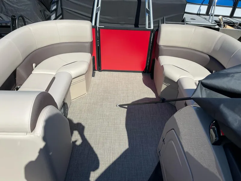 Slide: The Image of 2025 Bentley Pontoons Legacy 200 Swingback interior with beige seating and red accents. - 11