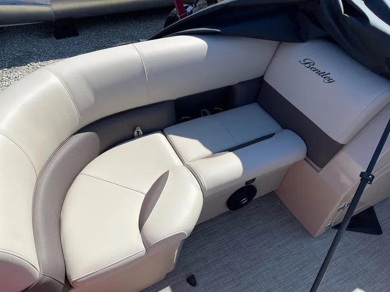 Slide: The Image of 2025 Bentley Pontoons Legacy 200 Swingback interior seating, featuring luxurious beige upholstery. - 13