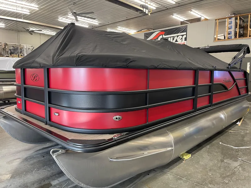Slide: The Image of 2025 Bentley Pontoons Legacy 200 Swingback in showroom, red and black design, covered. - 4