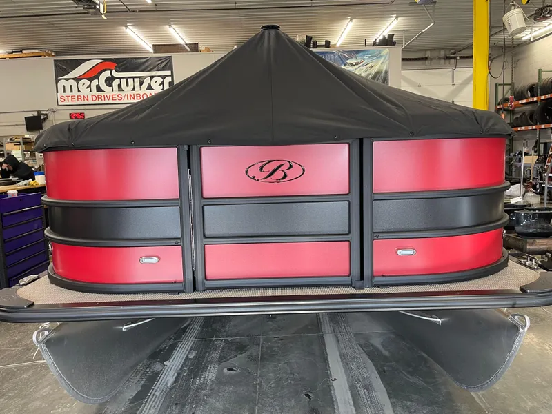 Slide: The Image of 2025 Bentley Pontoons Legacy 200 Swingback with red and black design in a showroom. - 5