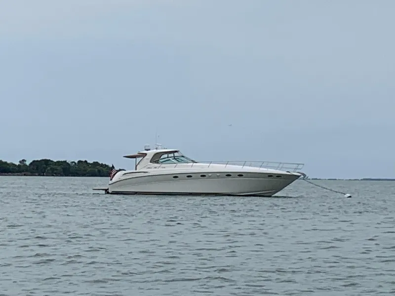 Slide: The Image of 2000 Sea Ray 510 Sundancer yacht anchored on calm water. - 1