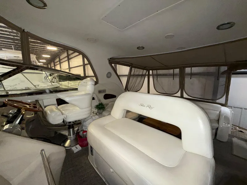 Slide: The Image of Interior of 2000 Sea Ray 510 Sundancer yacht with white seating and helm station. - 15