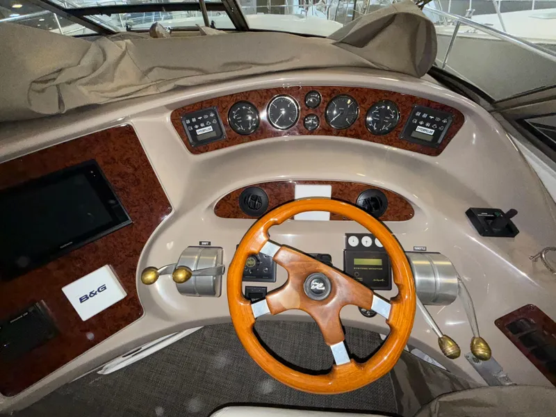 Slide: The Image of Cockpit of 2000 Sea Ray 510 Sundancer with wooden steering wheel and instrument panel. - 16