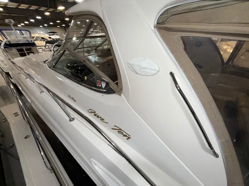 Slide: The Image of 2000 Sea Ray 510 Sundancer yacht in a showroom, showcasing sleek design and luxury features. - 2