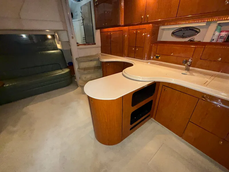 Slide: The Image of Interior of 2000 Sea Ray 510 Sundancer yacht with elegant wood cabinetry and modern amenities. - 24
