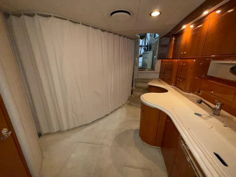 Slide: The Image of Interior of 2000 Sea Ray 510 Sundancer yacht with wooden cabinetry and curved countertops. - 26