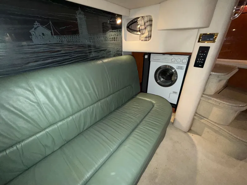 Slide: The Image of Interior of 2000 Sea Ray 510 Sundancer with green leather sofa and washing machine. - 27