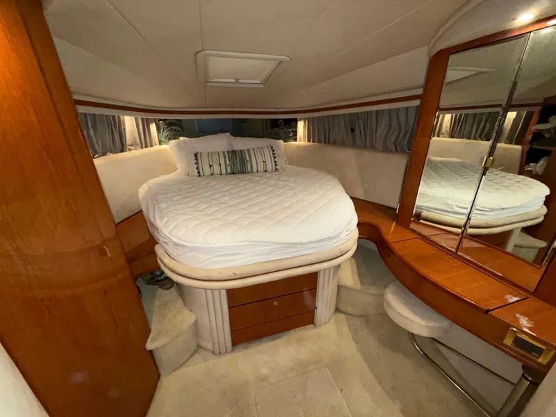 Slide: The Image of Luxurious bedroom interior of 2000 Sea Ray 510 Sundancer yacht with elegant wood finish. - 28