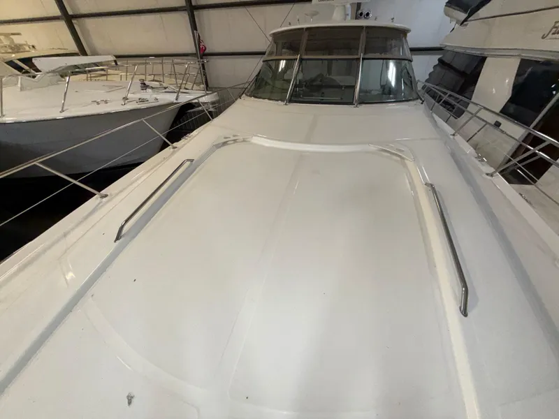 Slide: The Image of 2000 Sea Ray 510 Sundancer yacht in storage, showcasing sleek deck design. - 3