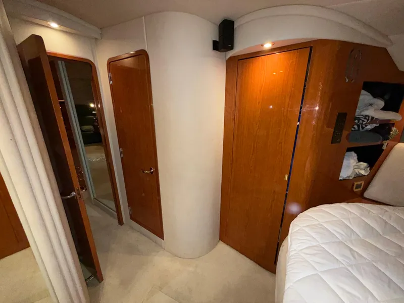 Slide: The Image of Interior of 2000 Sea Ray 510 Sundancer with wooden doors and cozy bedding. - 30
