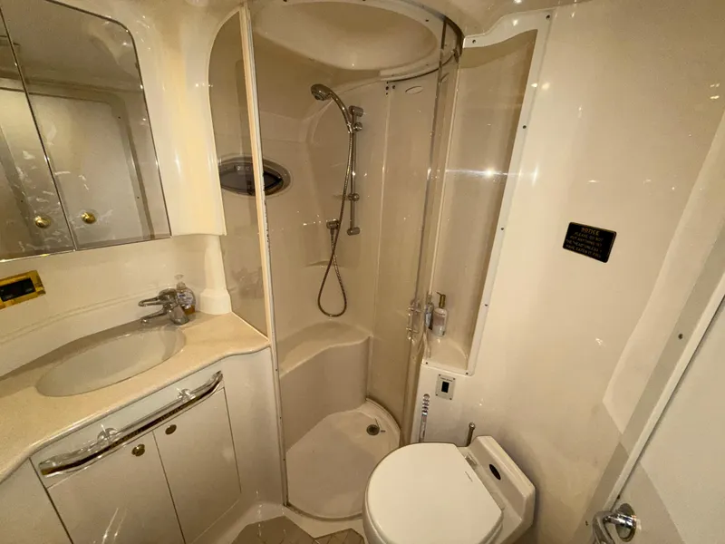 Slide: The Image of Bathroom interior of 2000 Sea Ray 510 Sundancer yacht, featuring shower, sink, and toilet. - 35