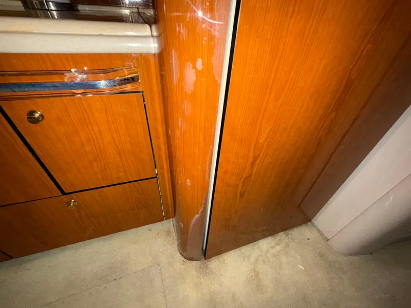 Slide: The Image of Wooden interior of 2000 Sea Ray 510 Sundancer yacht, showing cabinetry and flooring. - 38