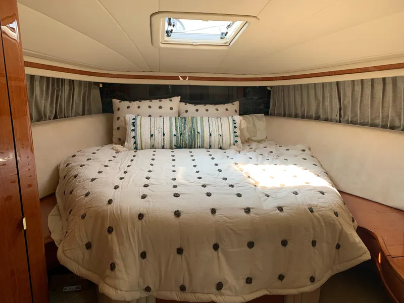 Slide: The Image of Cozy bedroom interior of 2000 Sea Ray 510 Sundancer yacht with skylight and plush bedding. - 39