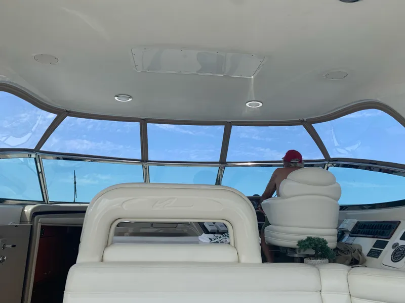 Slide: The Image of Interior view of 2000 Sea Ray 510 Sundancer yacht with person at helm. - 7